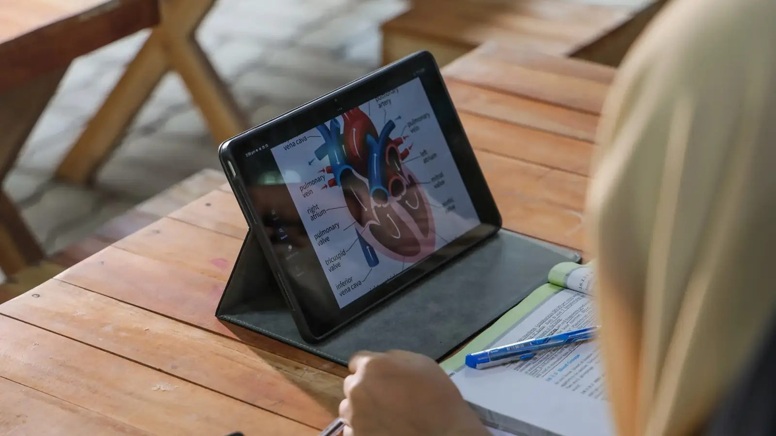 A student studying the human heart on a tablet